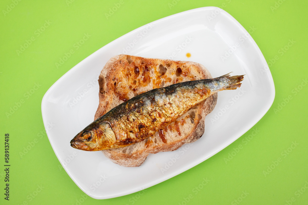 Grilled sardines with sauce on fresh bread Grilled sardines with sauce on fresh bread