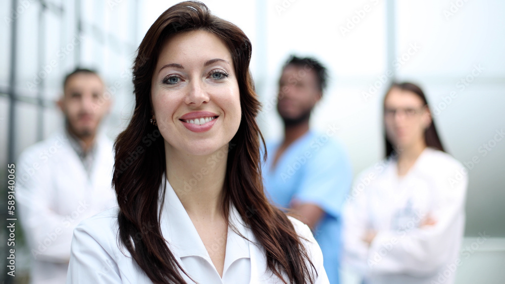 Fototapeta premium Portrait of a beautiful female doctor in a hospital, medical care.