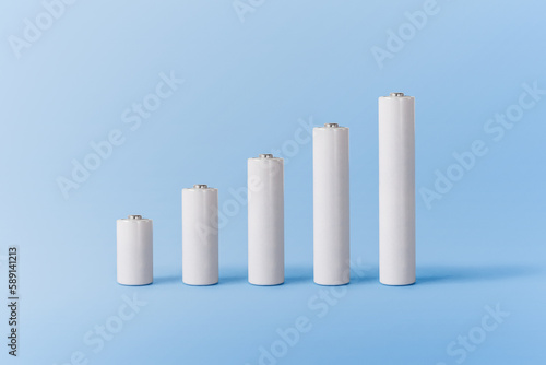 Various white batteries on blue surface