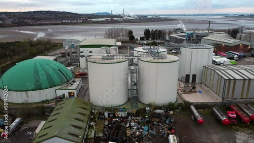 industrial green domed food waste biodegradable recycling silo facility aerial view low right orbiting shot photo