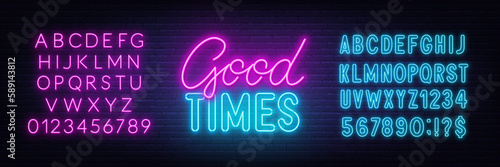 Good Times neon lettering on brick wall background.