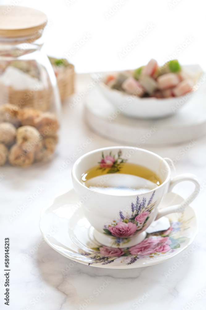 a cup of tea and dessert on the table a cup of tea and dessert on the table