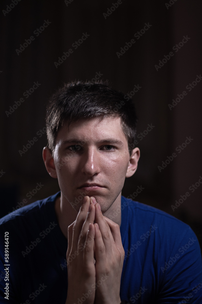 portrait of a young man on a dark background portrait of a young man on a dark background