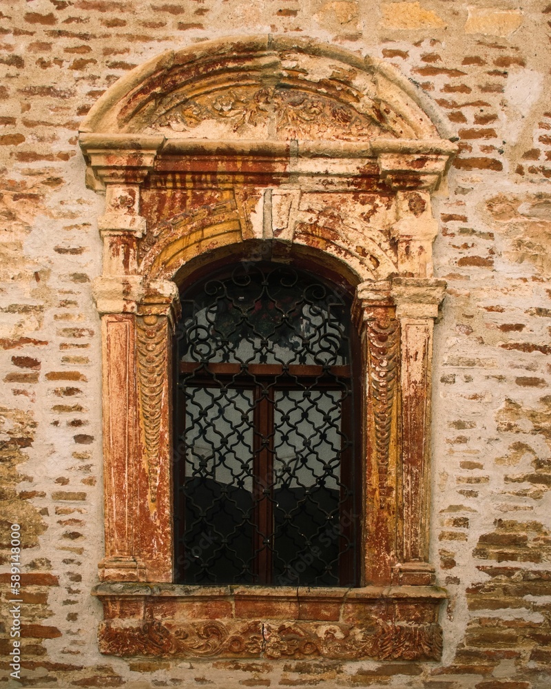 Black metal door in Brick stone with an arch exterior wall