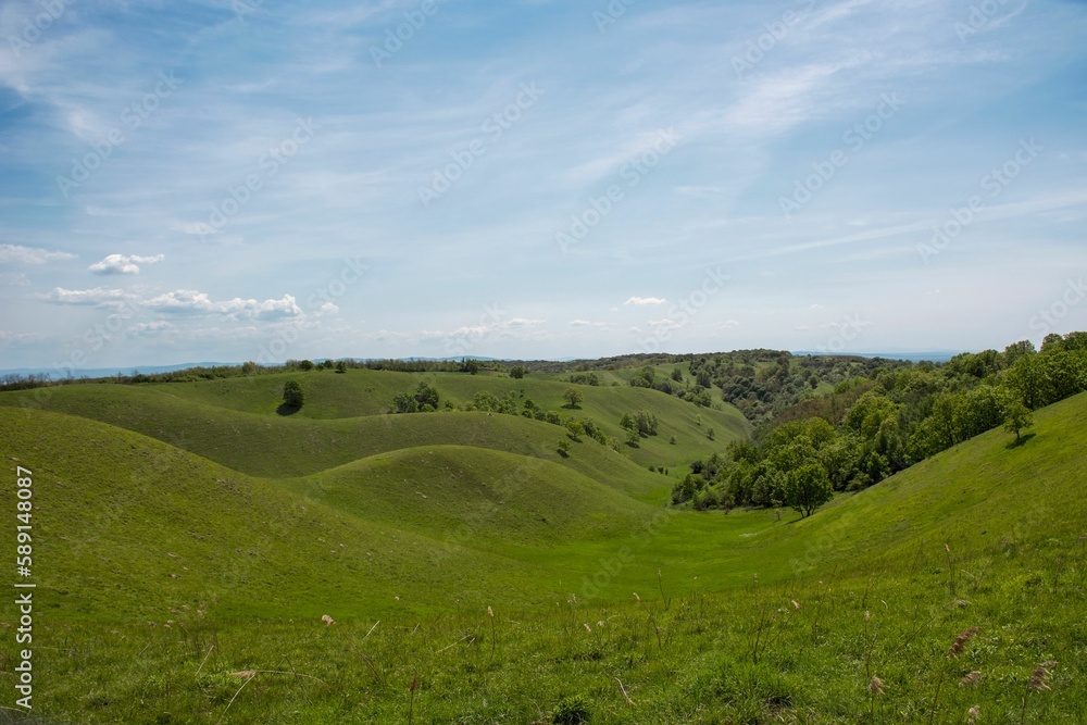 Scenic view of green hills in the countryside on a sunny day in summer Scenic view of green hills in the countryside on a sunny day in summer