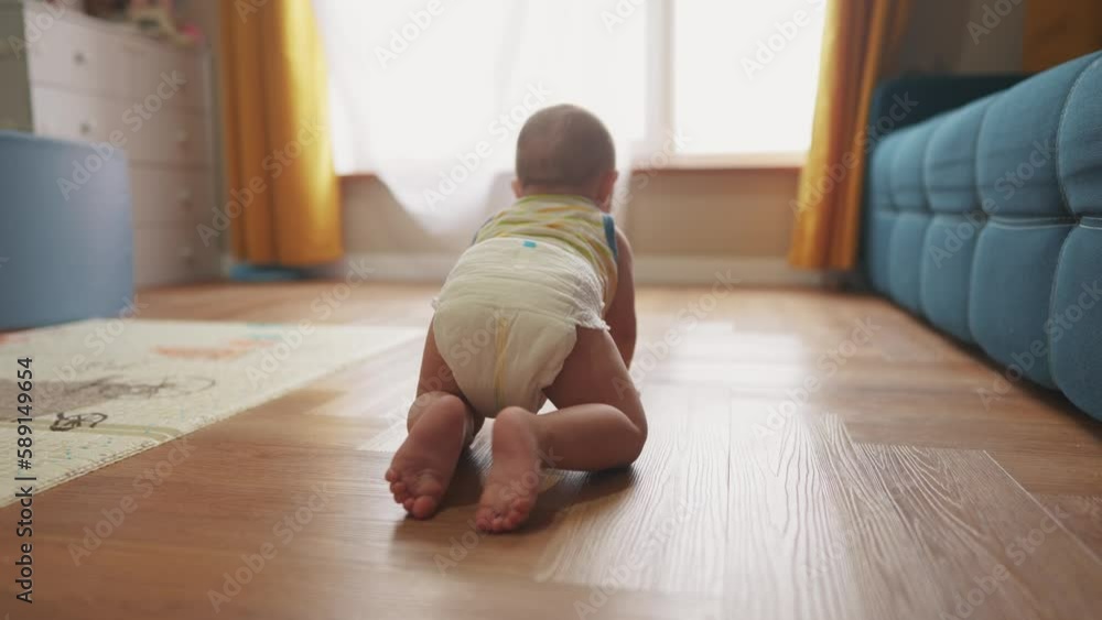 baby newborn crawling on the floor. happy family kindergarten kid concept. First steps, baby crawling view from the back. baby learns to crawl to explore the world dream. lifestyle first steps creeps baby newborn crawling on the floor. happy family kindergarten kid concept. First steps, baby crawling view from the back. baby learns to crawl to explore the world dream. lifestyle first steps creeps