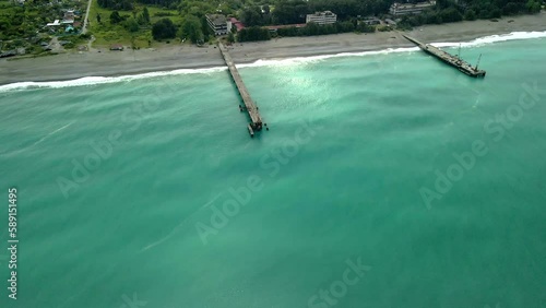 drone view of the bridge in the beautiful black sea on which there is a crane and cars. beautiful angle