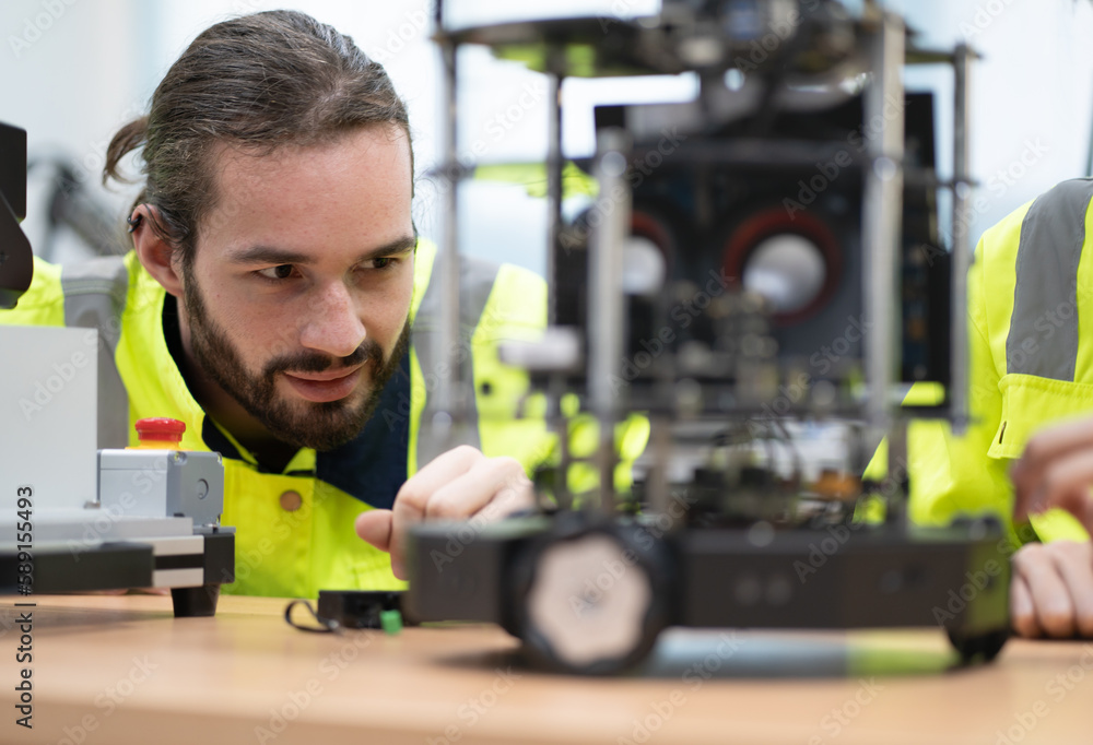 Robotic engineer monitoring robot arm connection for maintenance in