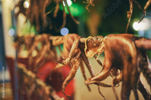 Fototapeta Naklejka Na Ścianę i Meble -  Octopus tentacles dried in a Greek tavern on the street in Greece.