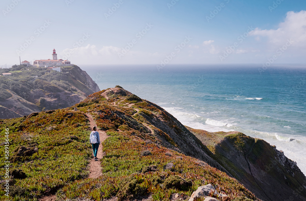 Famous lighthouse on Cabo da Roca, the western point of Europe. Beautiful landscape. Day time on the sea shore.