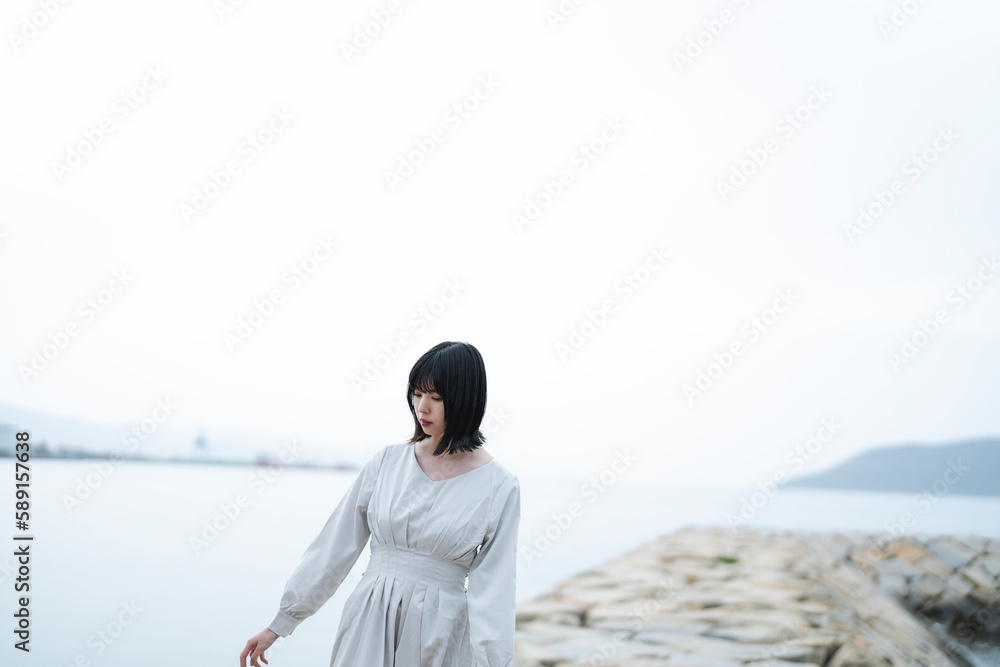 夕暮れの海にいる女性