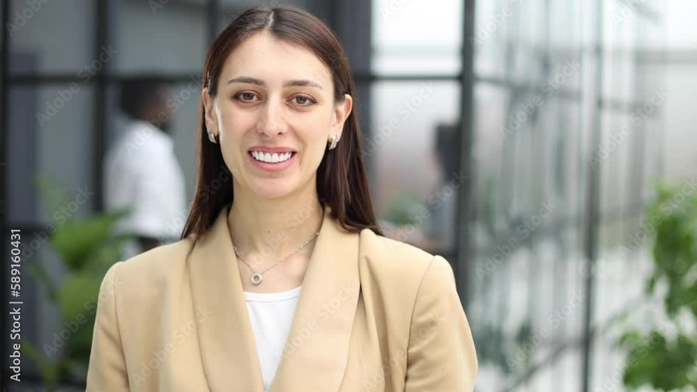 Portrait of a serious lady posing against the backdrop of a modern office. Portrait of a serious lady posing against the backdrop of a modern office.