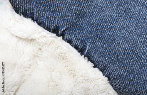 Background of white faux fur and jeans.