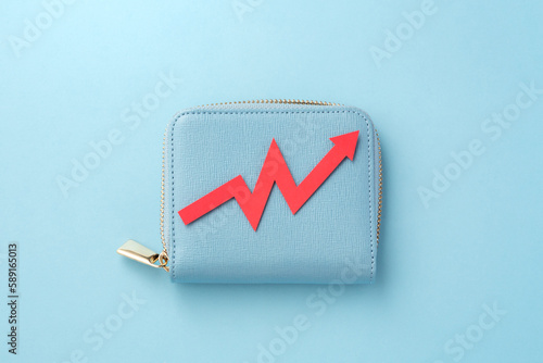 Tablou pe pânză Red graph going up on wallet on blue background