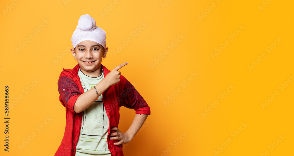 indian Sikh pointing towards the Left with copy space indian Sikh pointing towards the Left with copy space