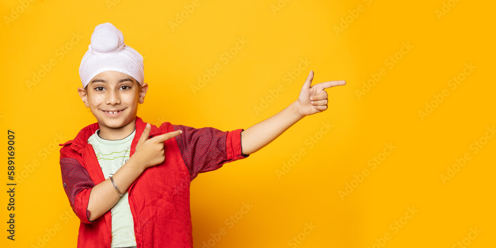 indian Sikh pointing towards the Left with copy space indian Sikh pointing towards the Left with copy space