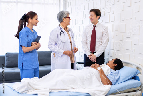 Hospital treatment room relative visit patient lay on bed doctor explain update illness condition