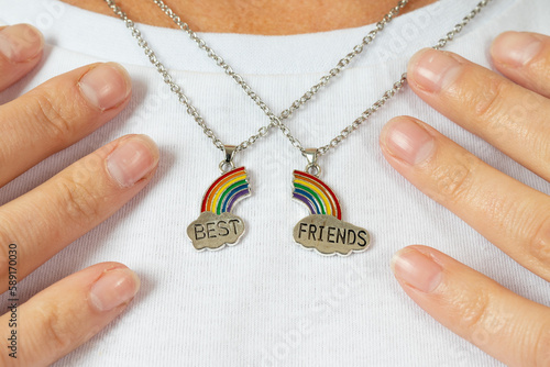 two pendants are best friends in the neckline on a white t-shirt. rainbow and cloud