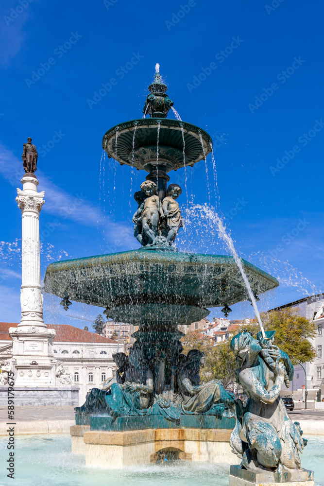 Rossio Square with fountain and monument of Pedro IV in Lisbon, Portugal.