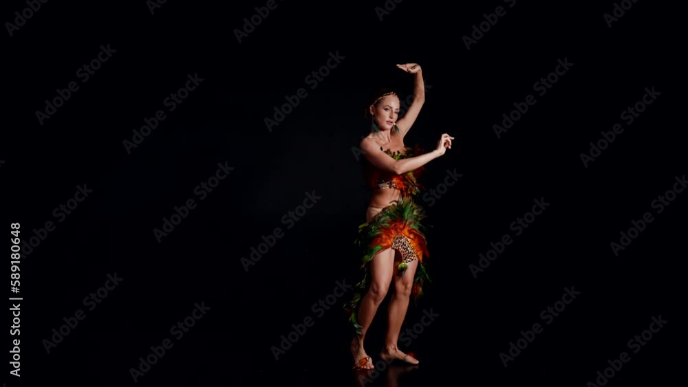 beautiful sexy woman in suit with feathers dancing modern choreography on stage, extravagant dance beautiful sexy woman in suit with feathers dancing modern choreography on stage, extravagant dance