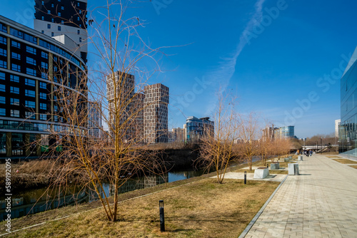 New high-rise buildings along the river on a sunny day.