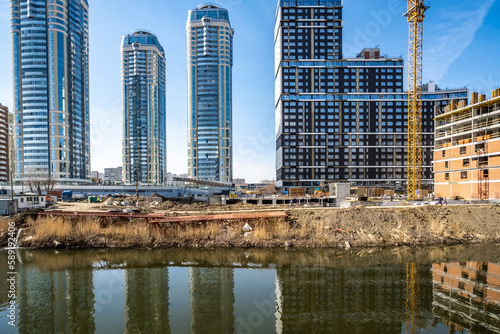Construction of new high-rise buildings on the river bank.