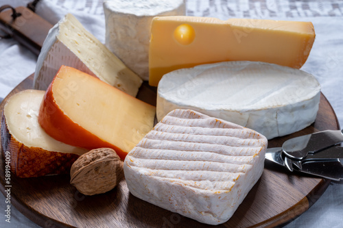 Collection of Belgian cheeses, soft yellow cow milk cheese with white mold from Bruges, bouquet des moines from Abbey of Val-Dieu, creamy cheese and beer cheeses photo