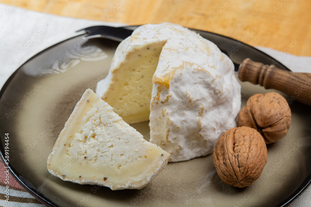 Cheese collection, soft cow French cheese with mold Gaperon artisanal lavored with cracked peppercorns and garlic produced in Auvergne Cheese collection, soft cow French cheese with mold Gaperon artisanal lavored with cracked peppercorns and garlic produced in Auvergne