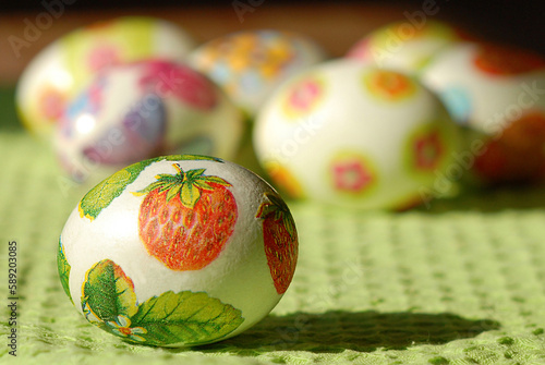 Colorful Easter eggs on country table on green tablecloth. Background and texture.Easter symbol. Spring festive concept.