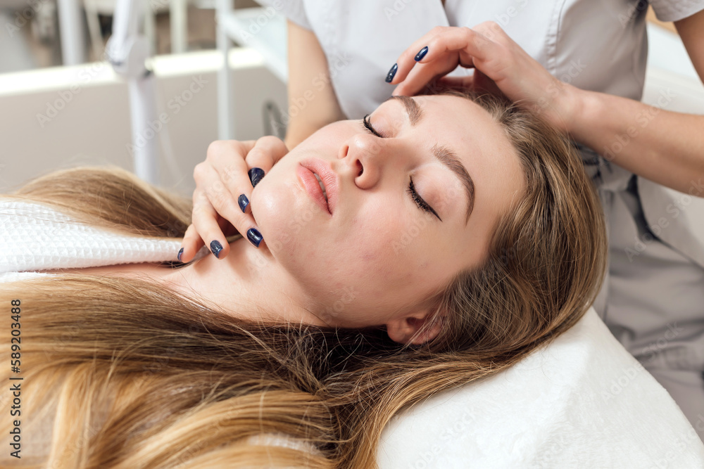 Beautician performs an analysis of the patient's facial skin Beautician performs an analysis of the patient's facial skin