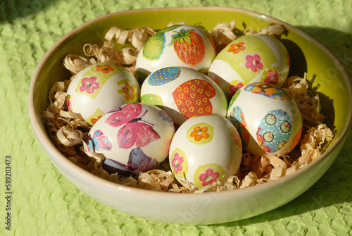 Colorful Easter eggs on country table on green tablecloth. Background and texture.Easter symbol. Spring festive concept.