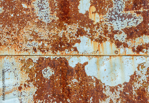 Light blue corroded metal background. Rusty and scratched painted metal wall. Rusty metal background with paint residue. photo