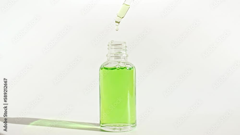 Glass cosmetic bottle with pipette. Sample of packaging for design, advertising. Natural Organic Cosmetics, Medicine. Production Close-up. Slow Motion. High quality 4k footage Glass cosmetic bottle with pipette. Sample of packaging for design, advertising. Natural Organic Cosmetics, Medicine. Production Close-up. Slow Motion. High quality 4k footage