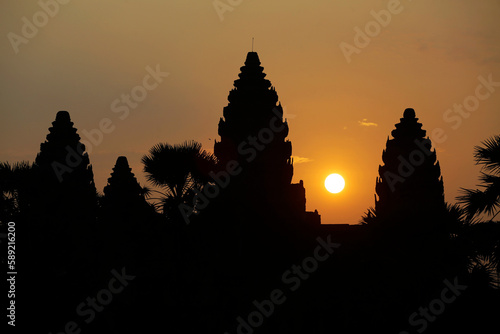 Silhouette of Angkor Wat temple during sunrise, located in Siem Reap, Cambodia. The Buddhist temple complex is considered the largest religious monument in the world.