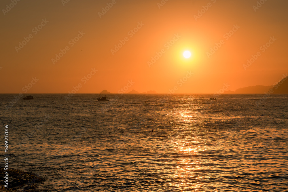 Sunset or sunrise in a orange sky at Arpoador beach