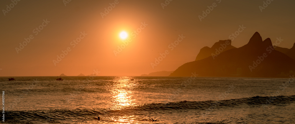 Sunset or sunrise in a orange sky at Arpoador beach panoramic