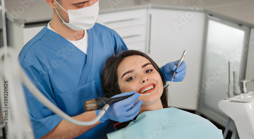 Image of smiling patient looking at camera at the dentist.