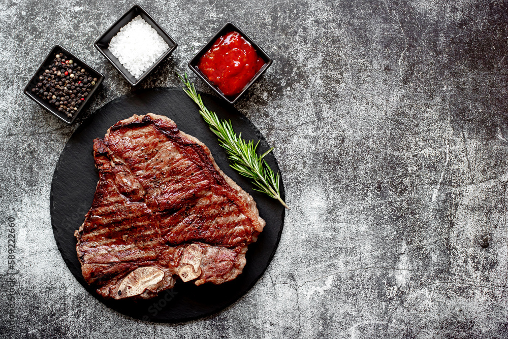 grilled T-bone steak on stone background with copy space for your text grilled T-bone steak on stone background with copy space for your text