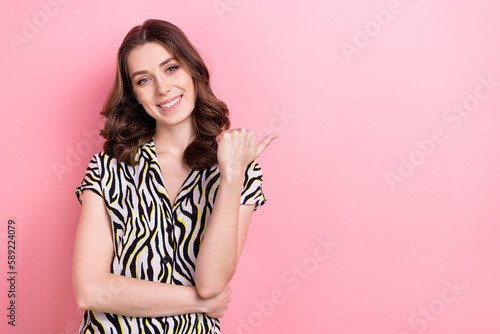 Photo of promoter young smiling happy lady curly hair wear zebra print blouse indicates empty space recommend brand isolated on pink color background © deagreez