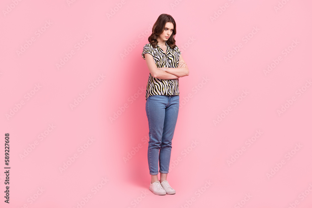 Full body photo of offended unsatisfied young lady folded hands isolated on pink color background Full body photo of offended unsatisfied young lady folded hands isolated on pink color background