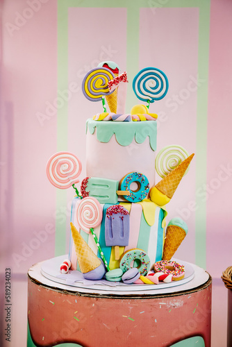 Multi-colored birthday cake for a one-year-old baby girl, decorated with colorful candies