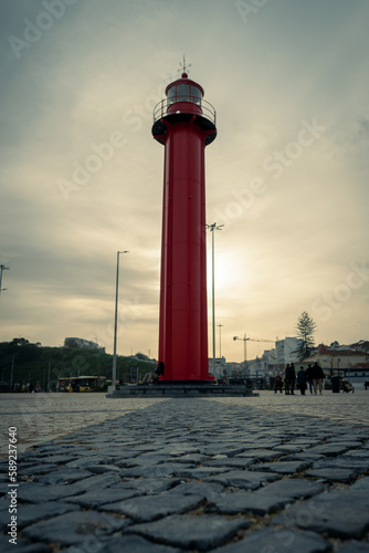 red lighthouse at sunset