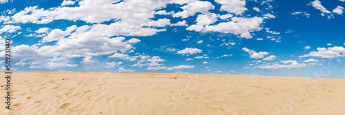 sand dunes and cloudy blue sky