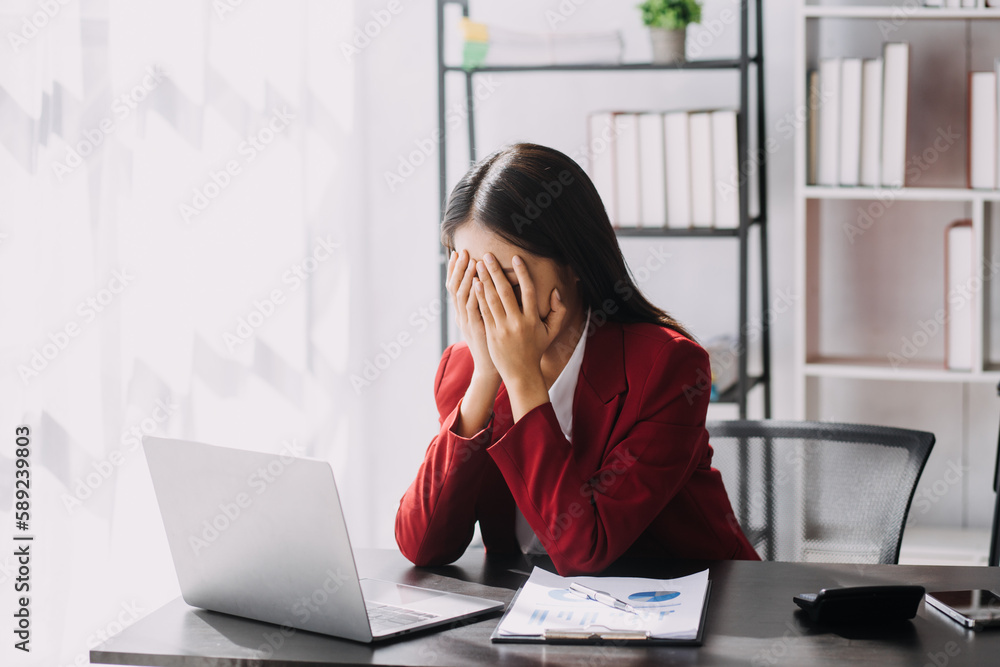 Asian women are stressed while working on laptop, Tired asian businesswoman with headache at office, feeling sick at work, copy space