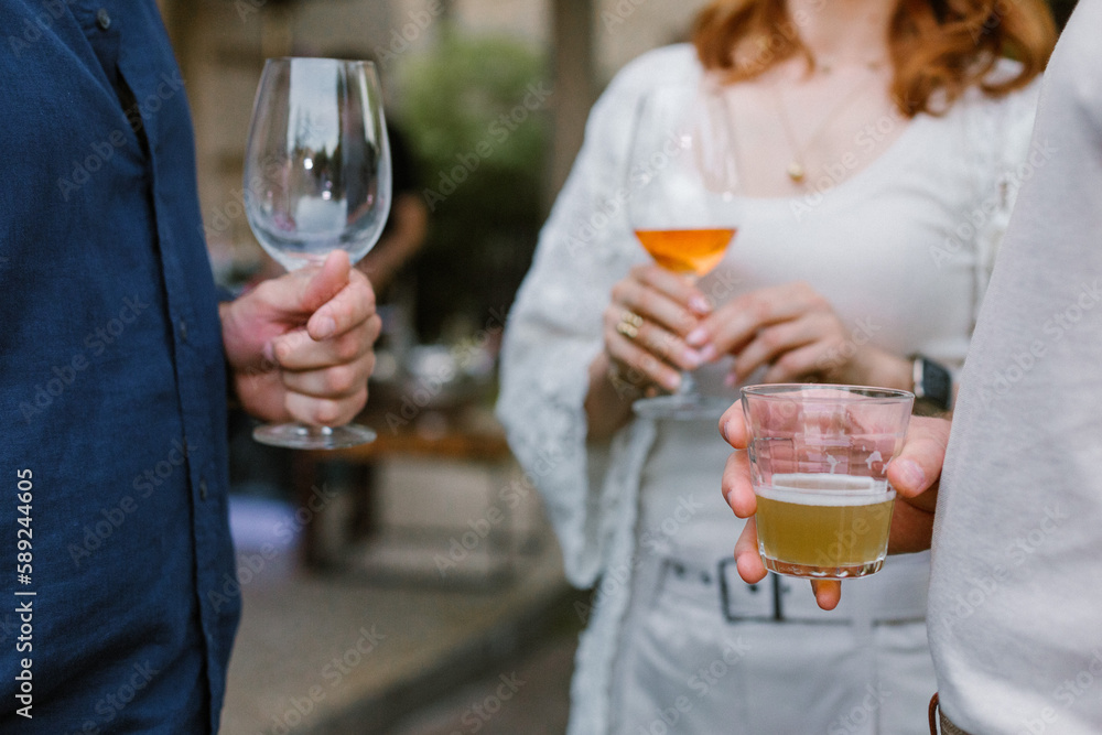 People holding glasses with alcohol wine and beer People holding glasses with alcohol wine and beer
