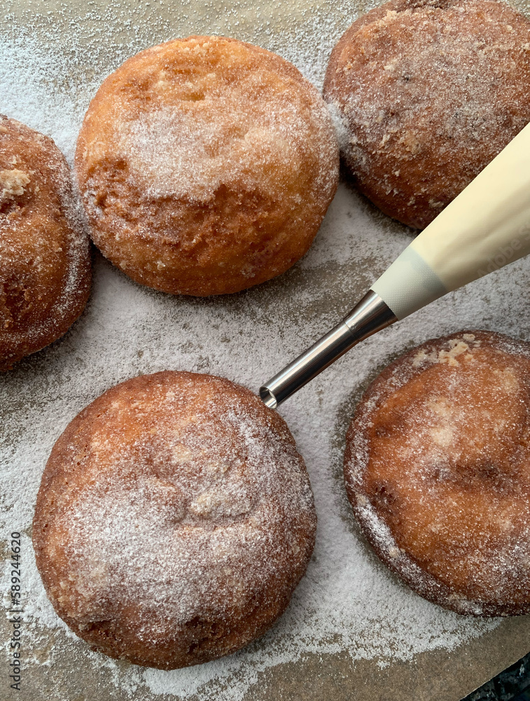 Naklejka premium Gluten and sugar-free donuts, homemade, with quark filling, erythritol powdered sugar,Piping bag with piping nozzle