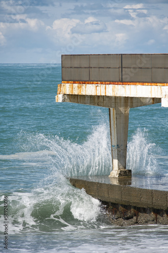 The wave crashes on the sea pier