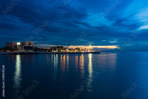 Pattaya, Thailand - September 5 2020 : Market walking area with many street shops and hotels in twilight view from the middle of the sea.