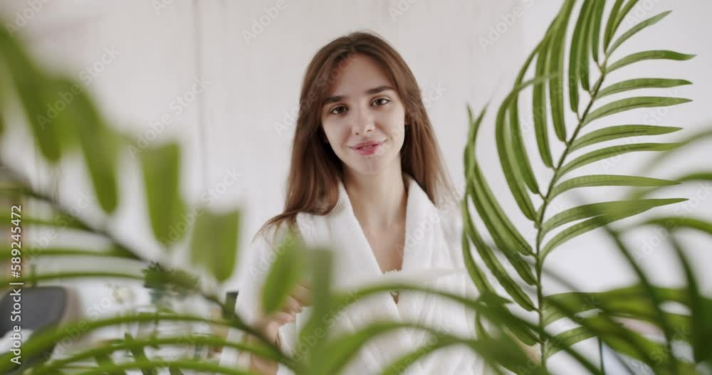 Beautiful Young Woman with Clean Fresh Skin. Beautiful woman enjoying smooth skin condition at home and smiling, slow motion. Skin care concept at home. Beautiful Young Woman with Clean Fresh Skin. Beautiful woman enjoying smooth skin condition at home and smiling, slow motion. Skin care concept at home.