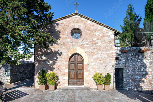 The church of Santa Margherita in Assisi, Umbria, Italy, July 5, 2021, front view , facade in summer light , horizontal photo 